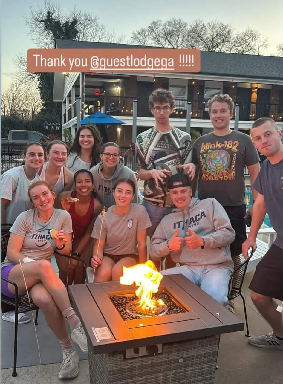 A group of young guests around the fire pit at The Guest Lodge